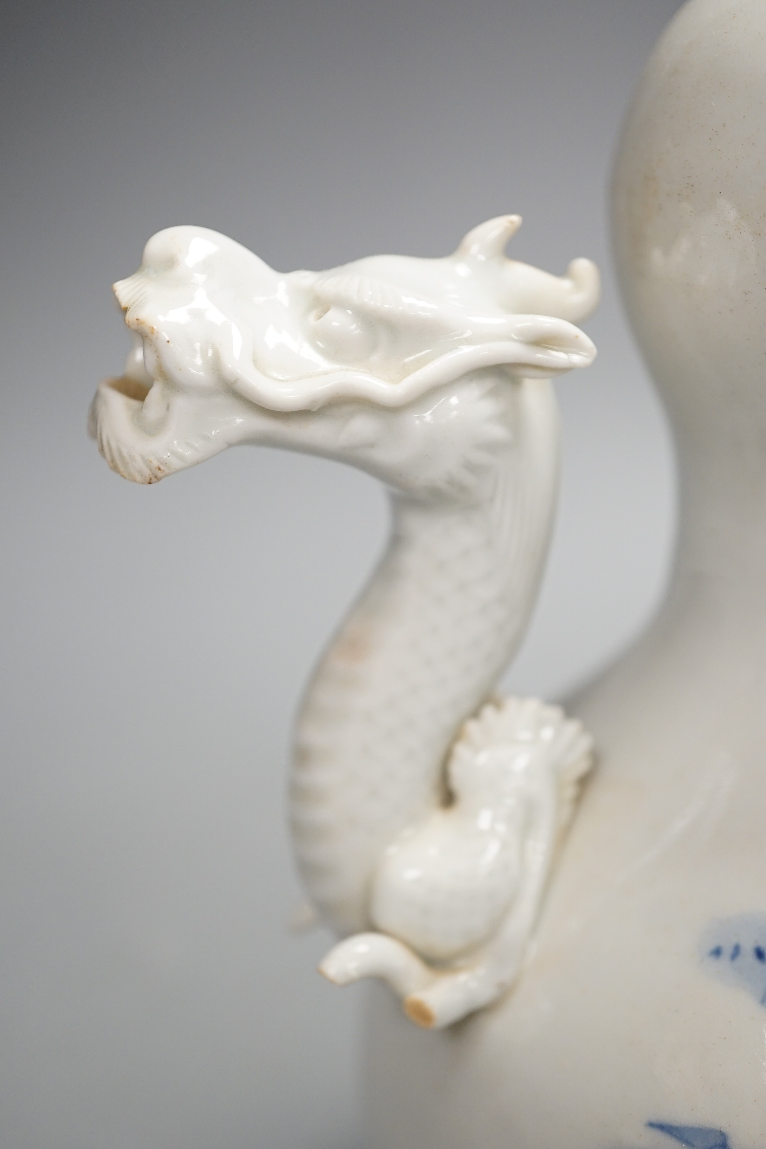 A Japanese Hirado blue and white 'dragon' wine pot, late 19th century, of double gourd shape, (losses) 19.5cm
